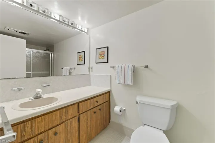 Full bath with a shower stall, vanity, and light tile patterned floors