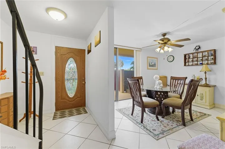 Entryway with plenty of natural light, light tile patterned floors, and a ceiling fan