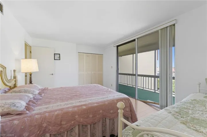 Bedroom with access to outside and a closet