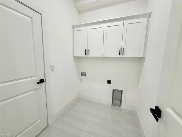 Indoor laundry with extra cabinets.