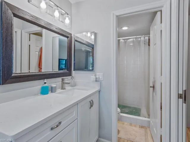 Bathroom with vanity, toilet, and a shower stall