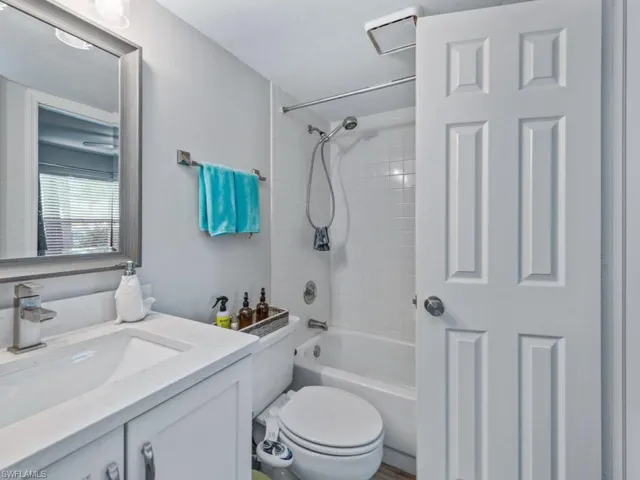Full bathroom with vanity, shower / washtub combination, and toilet