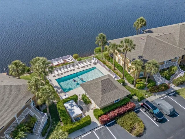 Drone / aerial view of a pool and a nearby body of water