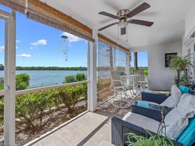 Sunroom featuring a water view and a ceiling fan