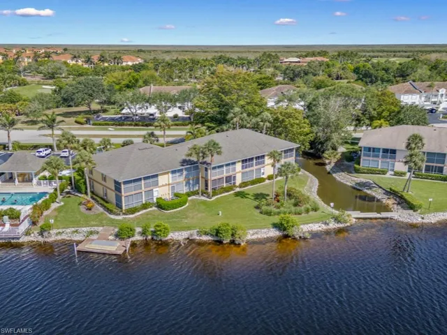 Aerial view of property and surrounding area featuring a large body of water