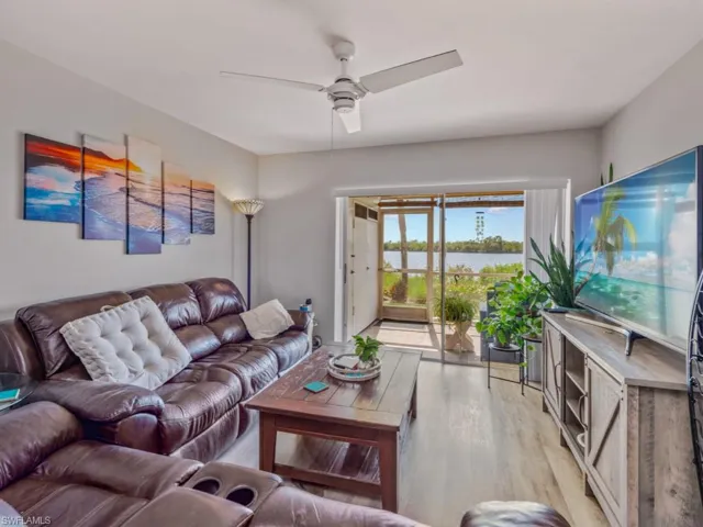 Living area featuring light wood-style floors and a ceiling fan