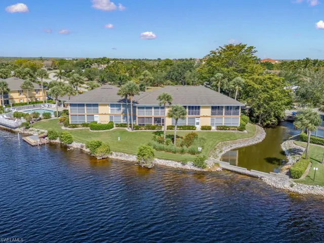 Aerial view of property and surrounding area featuring a large body of water