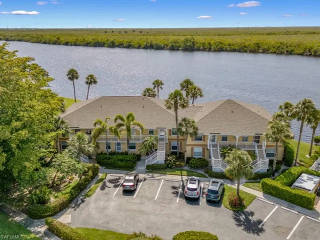 Drone / aerial view of a large body of water and a heavily wooded area