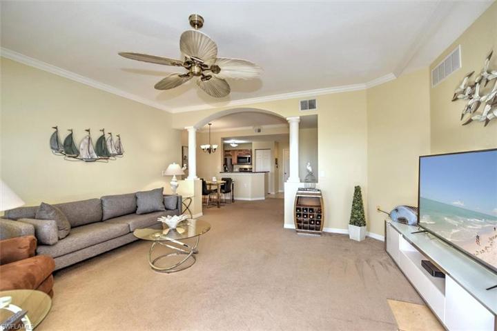 Open concept living room with stately pillars!