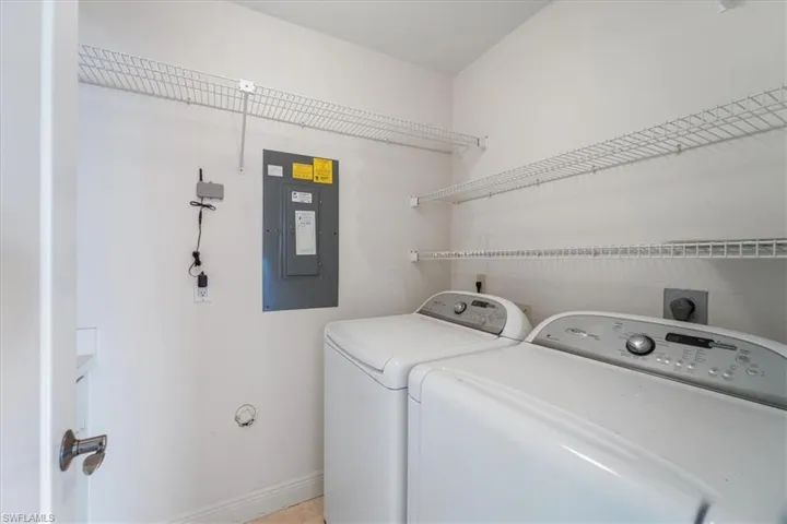 Washroom with electric panel and washing machine and clothes dryer