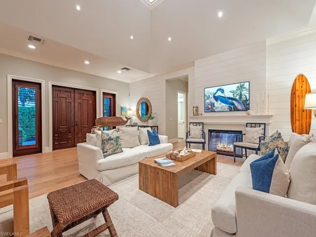 Enter the home through custom solid wood doors with two side lights.