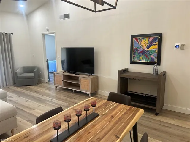 Living area with large screen TV and rolling bar