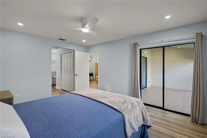 Primary bedroom view leading to primary bath with larger closet reconfigured from great room
