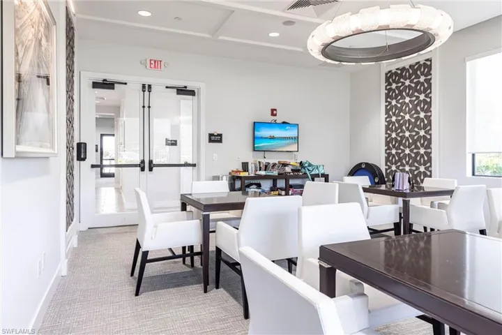 Dining space with recessed lighting, light carpet, and french doors