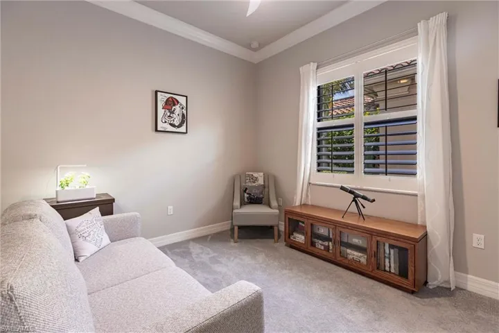 Sitting room featuring crown molding, carpet flooring, and baseboards