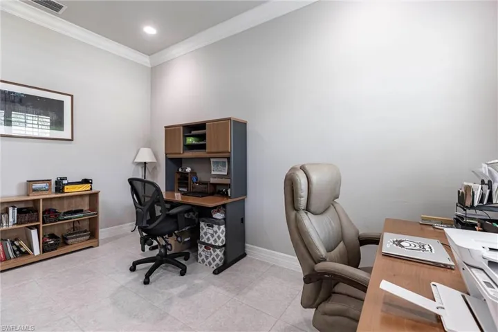 Office space featuring ornamental molding, light tile patterned floors, and baseboards