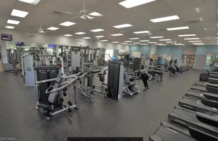 Gym featuring a paneled ceiling and a ceiling fan