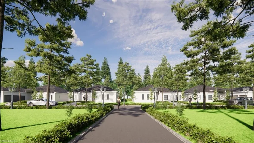 Paved community road bordered by manicured hedges and mature trees