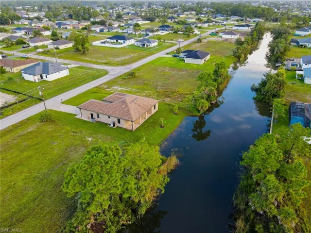 Aerial perspective of suburban area featuring a large body of water