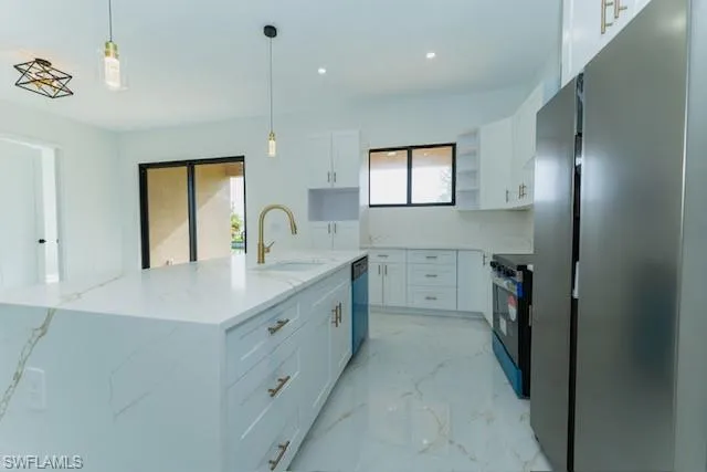 Kitchen featuring stainless steel appliances, light marble finish floors, white cabinetry, pendant lighting, and recessed lighting
