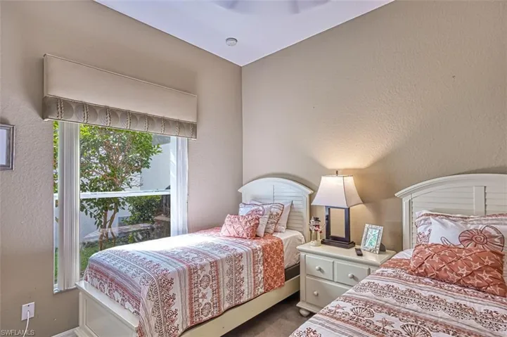 Carpeted bedroom with a textured wall