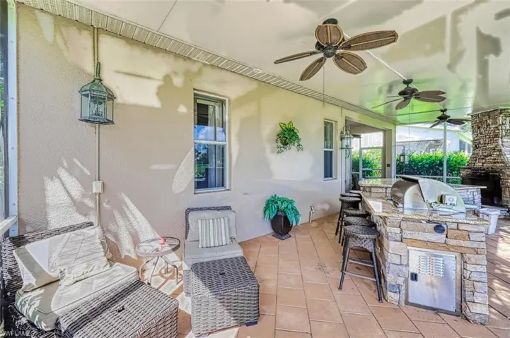 View of patio featuring area for grilling and a sunroom