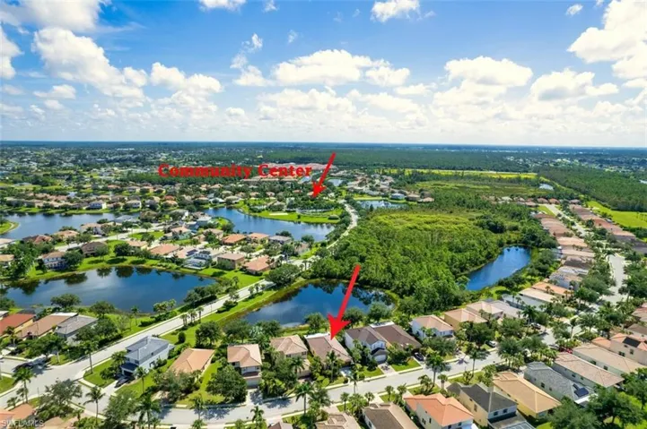 View of property location featuring a large body of water and nearby suburban area