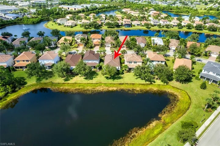 Aerial view of property's location featuring a large body of water and nearby suburban area