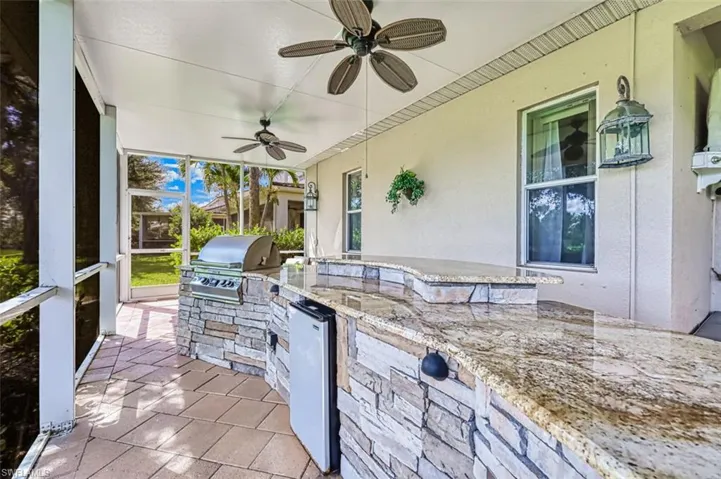 View of patio / terrace featuring a sunroom, area for grilling, and a ceiling fan