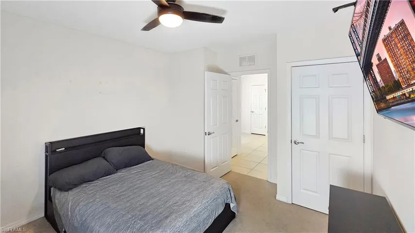 Bedroom featuring ceiling fan, carpet, visible vents, and baseboards