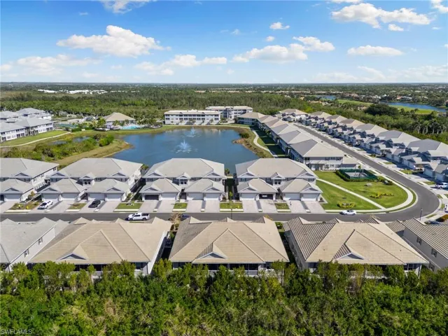 Drone / aerial view with a residential view and a water view