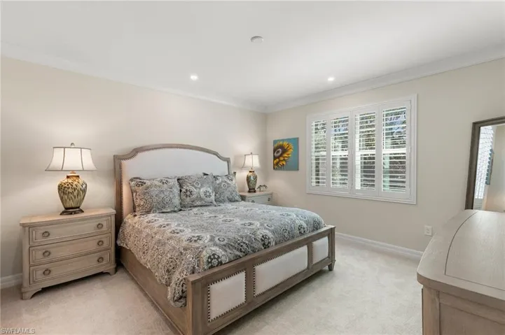 Bedroom with recessed lighting, baseboards, light colored carpet, and crown molding