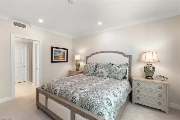 Bedroom featuring visible vents, baseboards, light colored carpet, ornamental molding, and recessed lighting