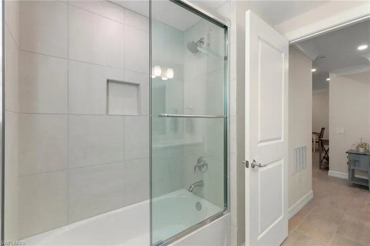 Bathroom featuring visible vents, recessed lighting, baseboards, tile patterned flooring, and enclosed tub / shower combo