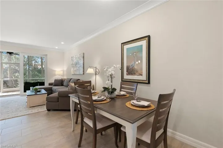 Dining area with crown molding and baseboards