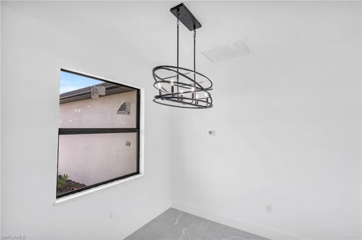 Spare room featuring a chandelier