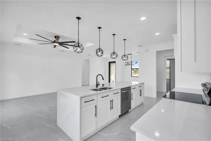 Unfurnished room with ceiling fan and a raised ceiling