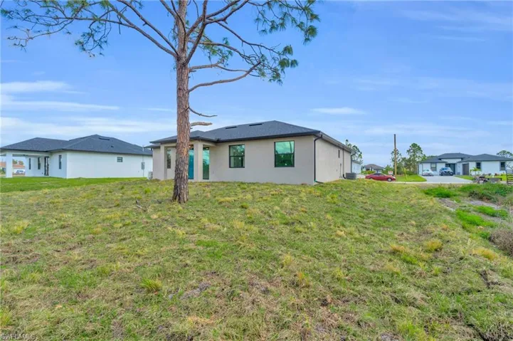 Rear view of property featuring a lawn