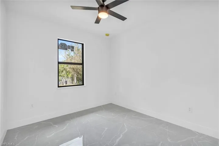 Spare room with ceiling fan