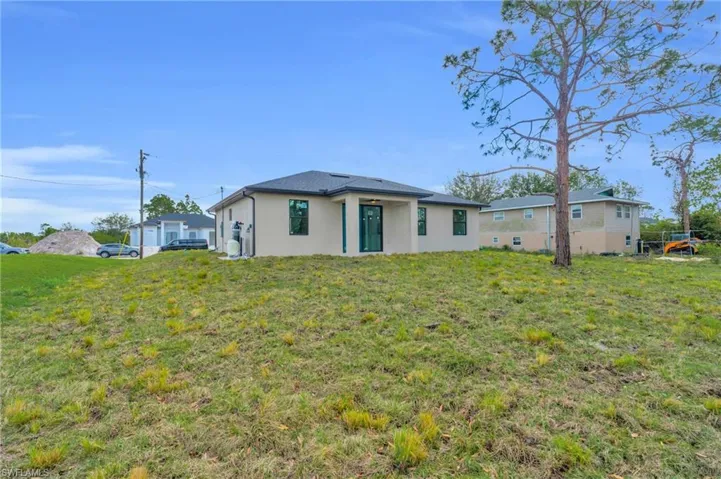 Rear view of property with a yard