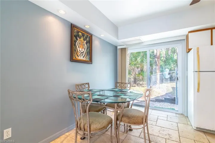 Dining room featuring stone tile flooring and recessed lighting