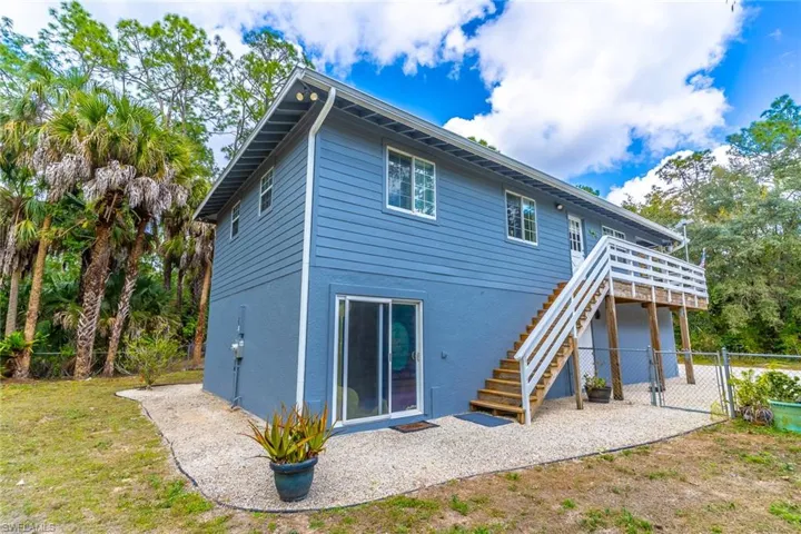 Back of house with a gate and a patio area