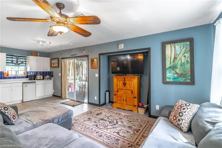 Living room with LVP floors and a ceiling fan
