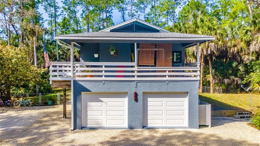 View of front of house with an attached 2 car garage, covered porch, a New roof