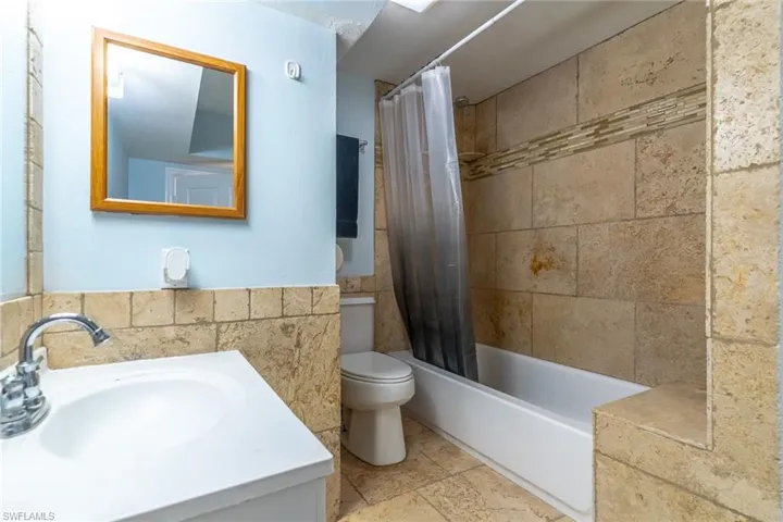 Full bathroom with vanity and shower / tub combo