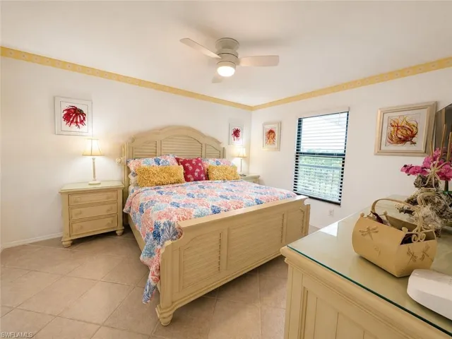 Spacious room featuring tile flooring, a window with horizontal blinds, and a ceiling fan with integrated lighting