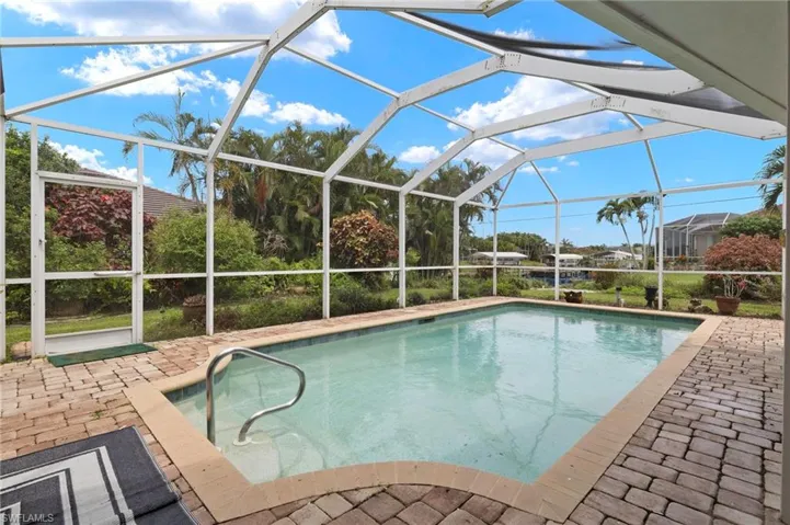 Swimming pool with a patio and a lanai