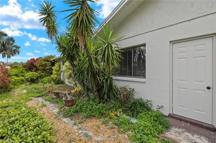 View of side of home featuring stucco siding