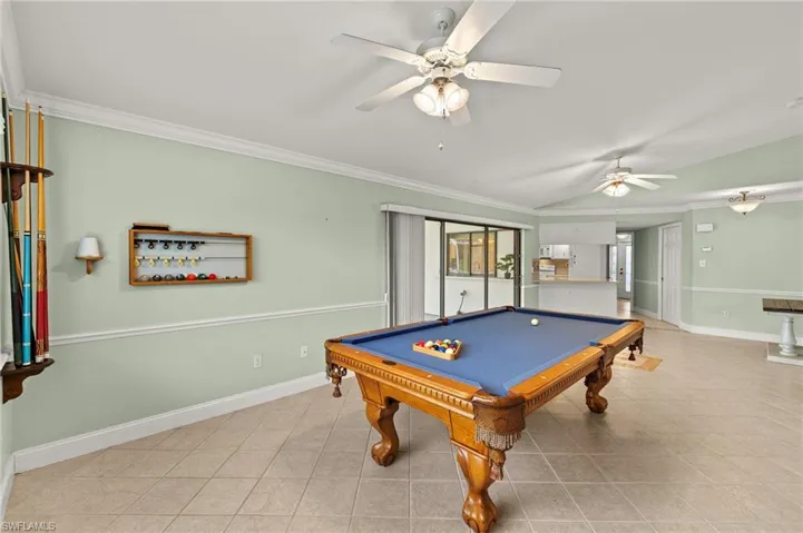 Recreation room featuring a ceiling fan, crown molding, baseboards, tile patterned flooring, and billiards table
