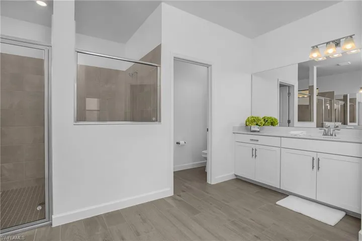 Primary bath with dual sinks, separate water closet, and walk in shower.